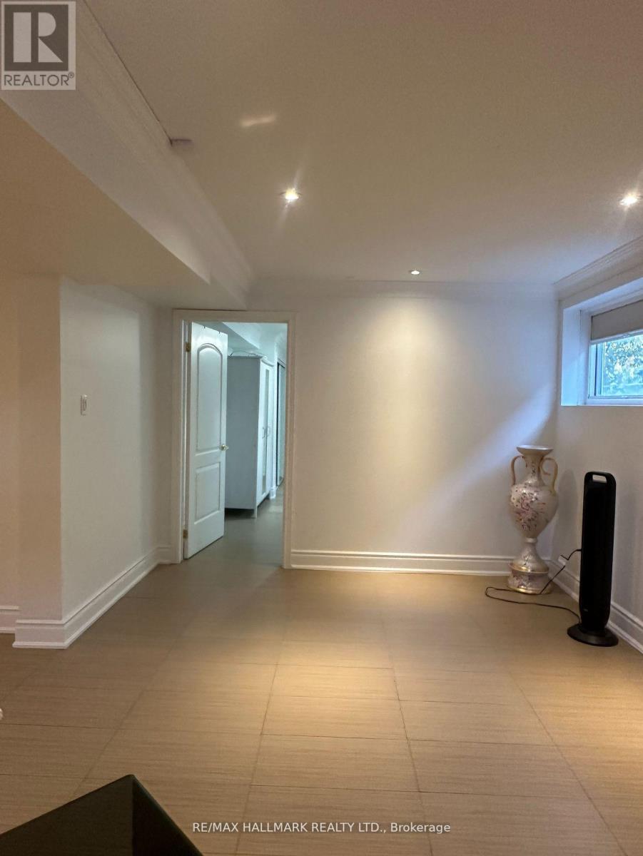 A spacious room with a black speaker on the floor.