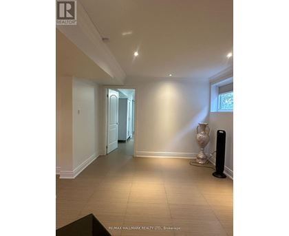 A spacious room with a black speaker on the floor.