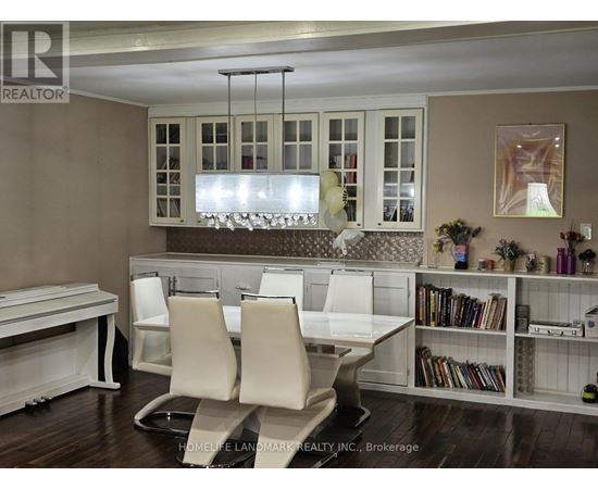 A dining room with a table and chairs.