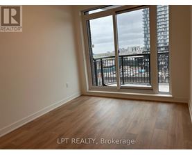A room with a view of a construction site through the window.