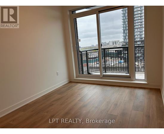 A room with a view of a construction site through the window.