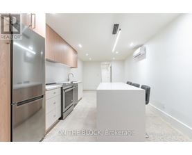 A modern kitchen with stainless steel appliances and wooden cabinets.