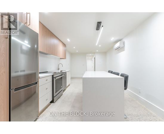 A modern kitchen with stainless steel appliances and wooden cabinets.
