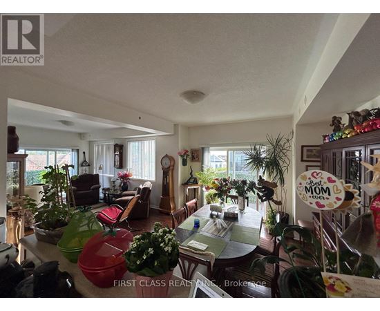 A living room with a dining table and chairs.