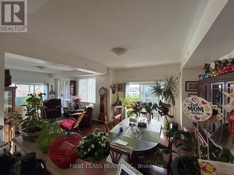 A living room with a dining table and chairs.