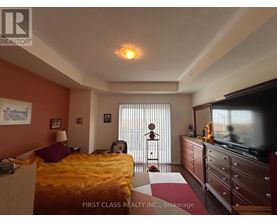 A bedroom with a bed, dresser, and television.