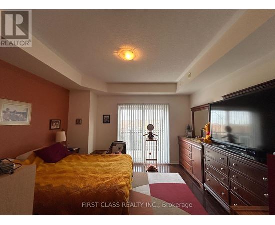 A bedroom with a bed, dresser, and television.