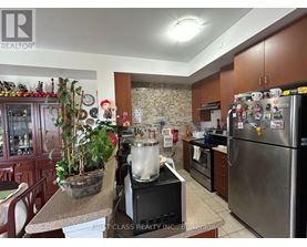 A kitchen with a refrigerator covered in magnets and a pot on the stove.