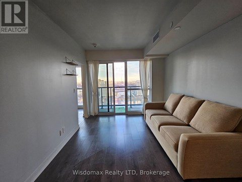 A living room with a couch and sliding glass doors.