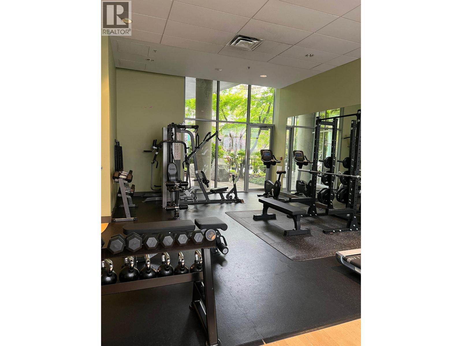A gym with a variety of equipment including weights and machines.