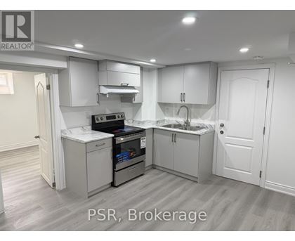 A kitchen with white cabinets and appliances is on the market.