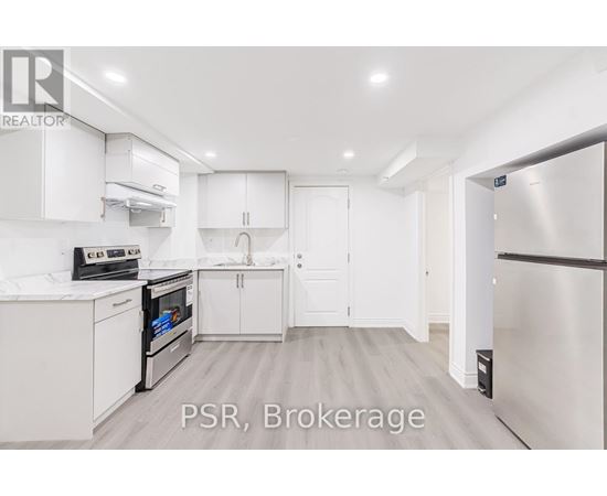 A kitchen with white cabinets and appliances is on the market.