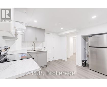 A kitchen with a refrigerator and cabinets.
