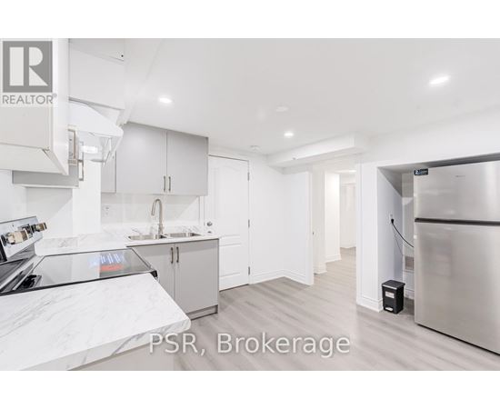 A kitchen with a refrigerator and cabinets.