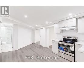 A kitchen with a stove top oven and a refrigerator.