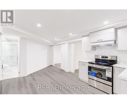 A kitchen with a stove top oven and a refrigerator.