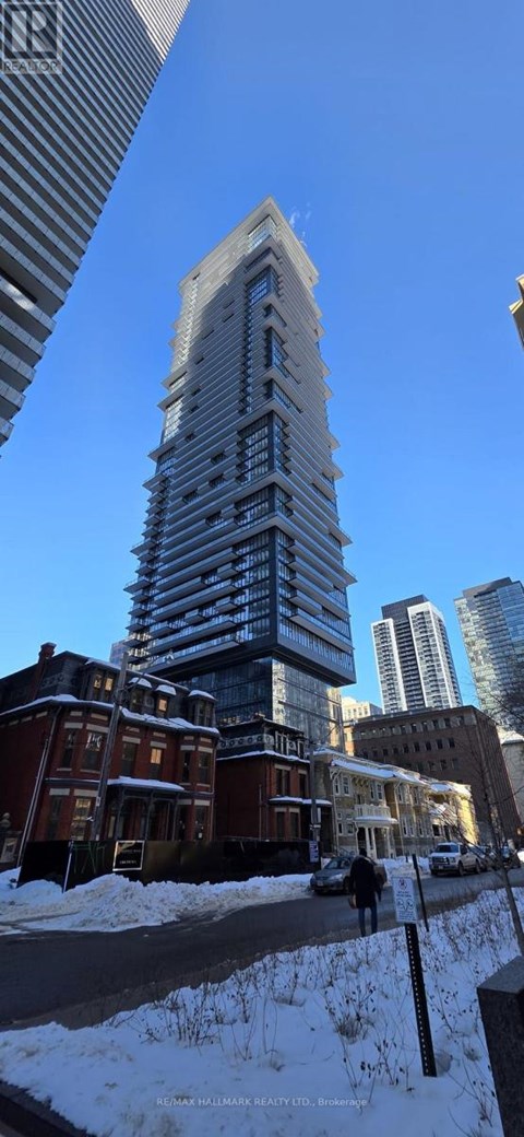 A tall building stands in the snowy cityscape.