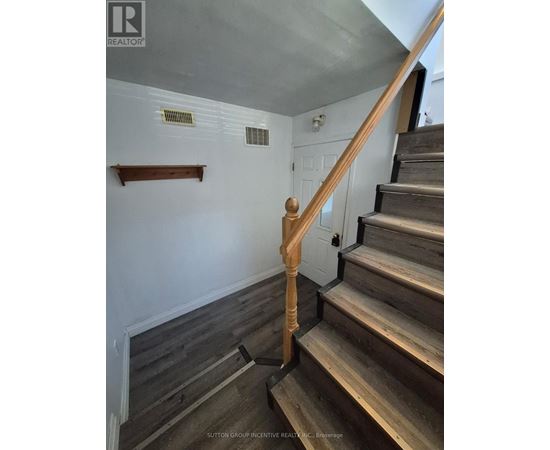 A staircase with wooden steps and handrail.