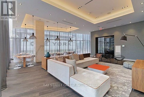 A modern living room with a white sofa and a wooden coffee table.