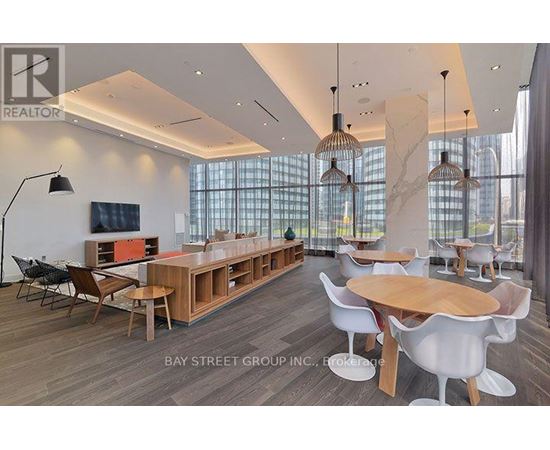 A modern dining room with a long table and chairs.