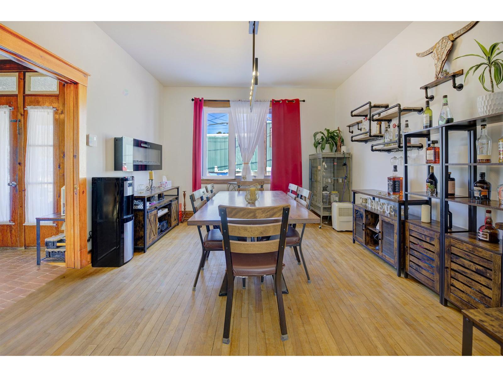 A kitchen with a table and chairs in the middle of the room.