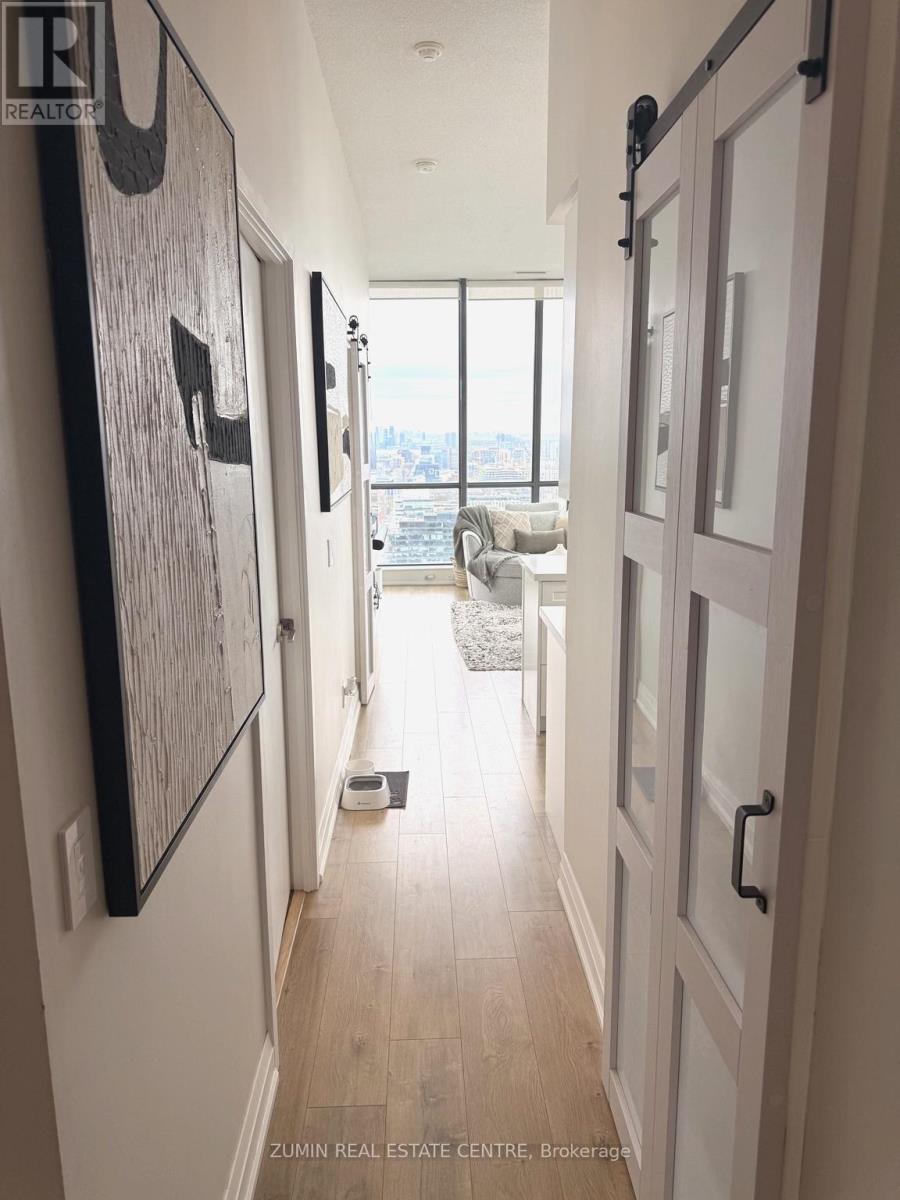 A hallway with a real estate sign on the wall.