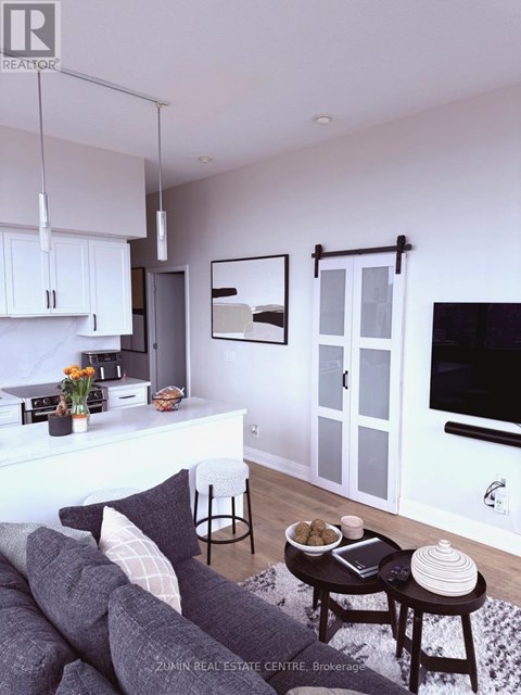 A living room with a grey couch and a coffee table.