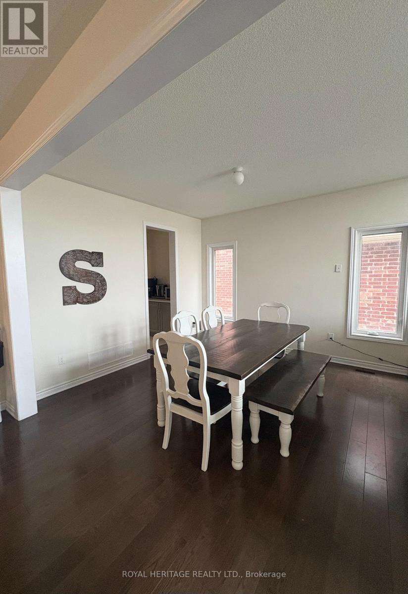 A dining room with a table and chairs.