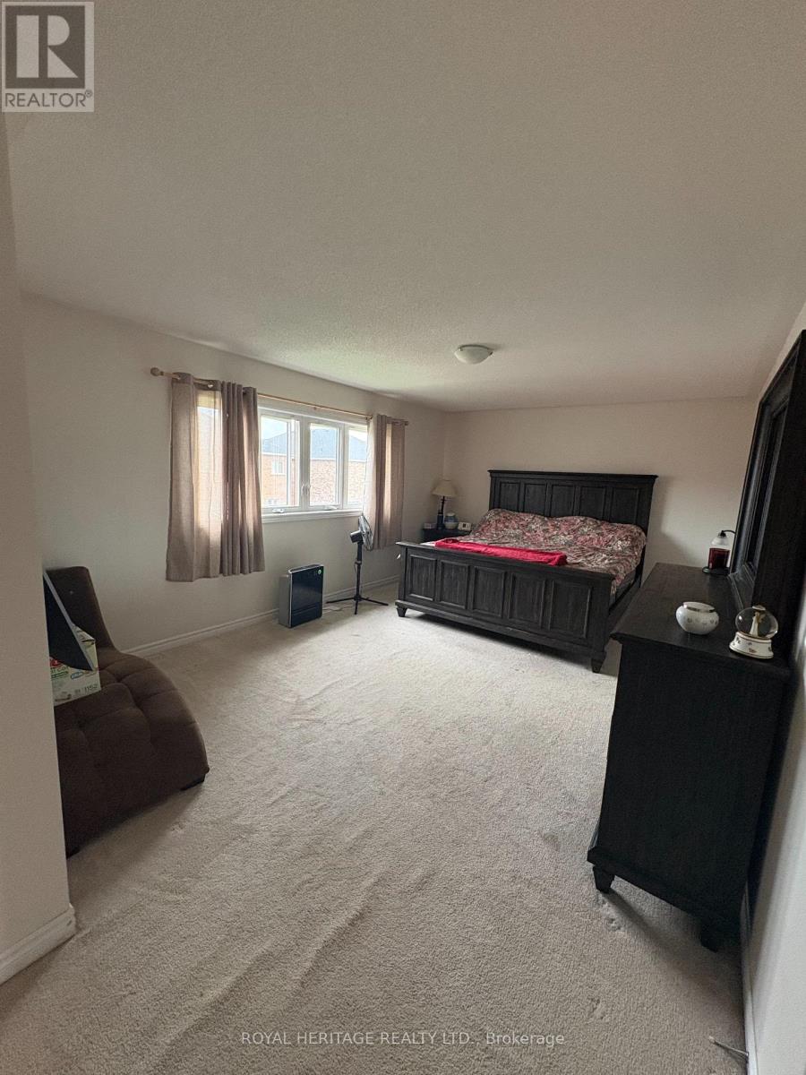 A bedroom with a bed, nightstand, and chair.