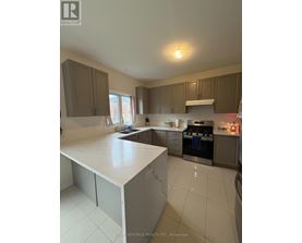 A kitchen with a white counter top and brown cabinets.