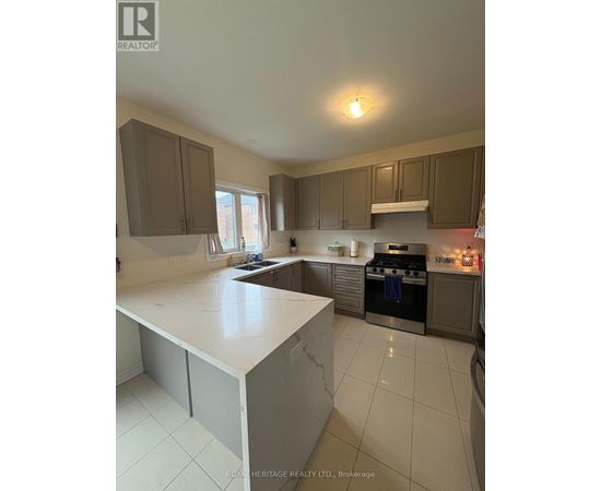 A kitchen with a white counter top and brown cabinets.