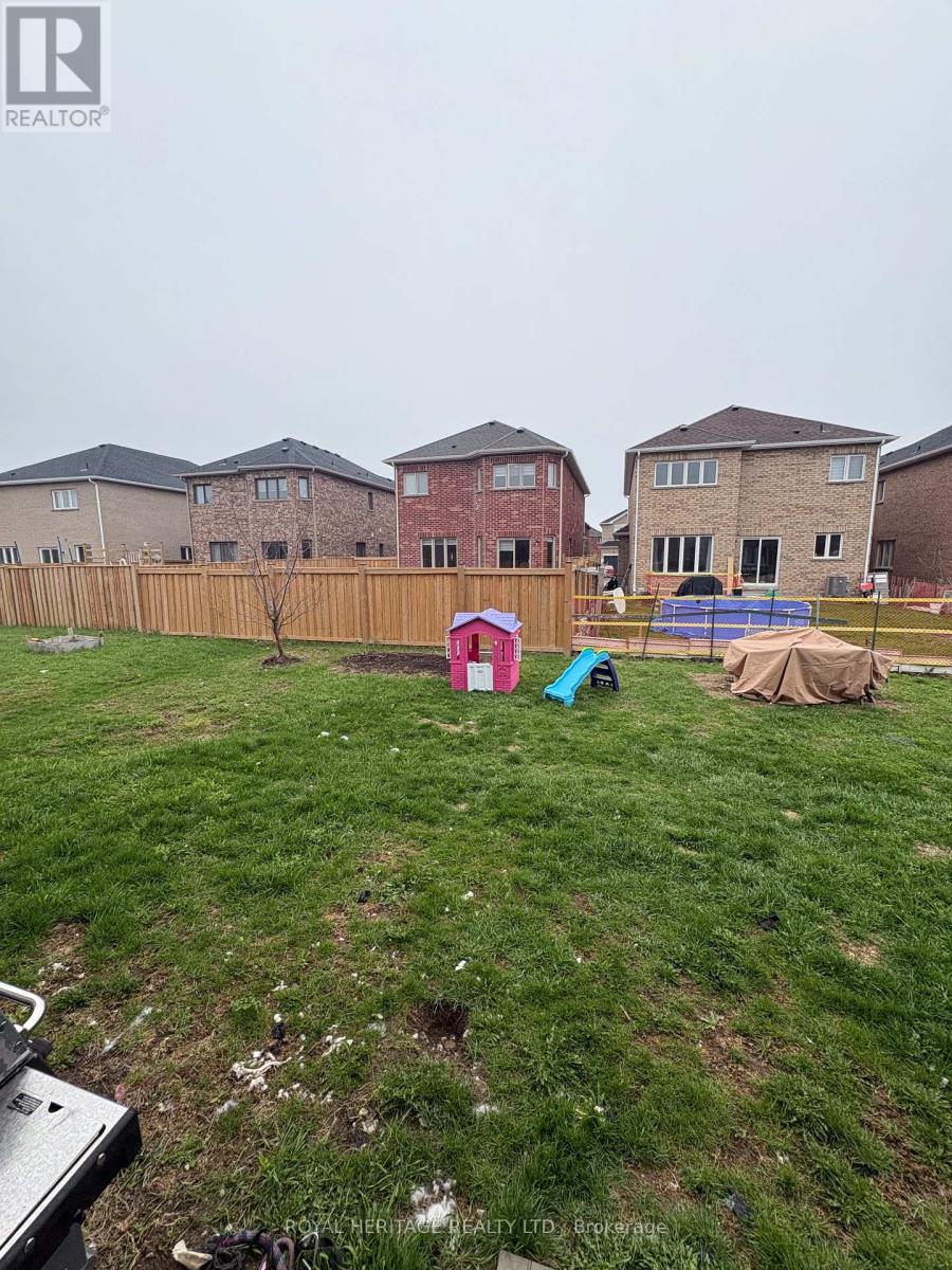 A backyard with a fence and a swimming pool.