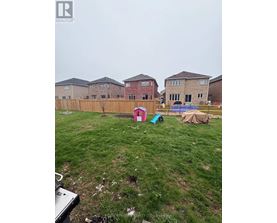 A backyard with a fence and a swimming pool.