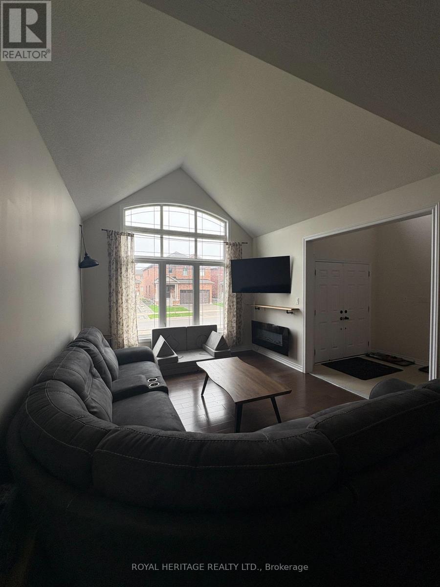 A living room with a grey couch and a television.