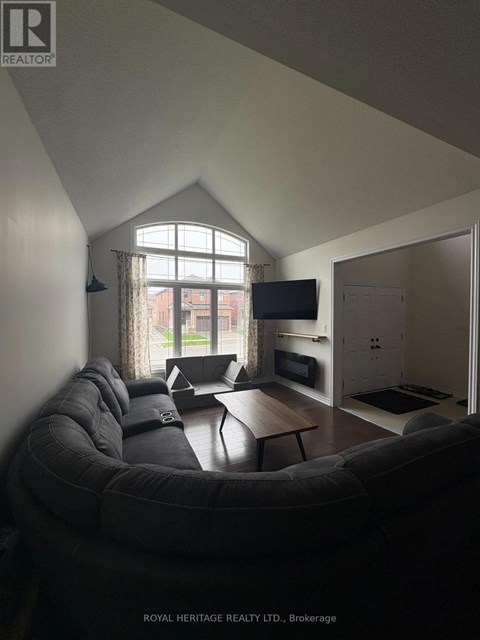 A living room with a grey couch and a television.