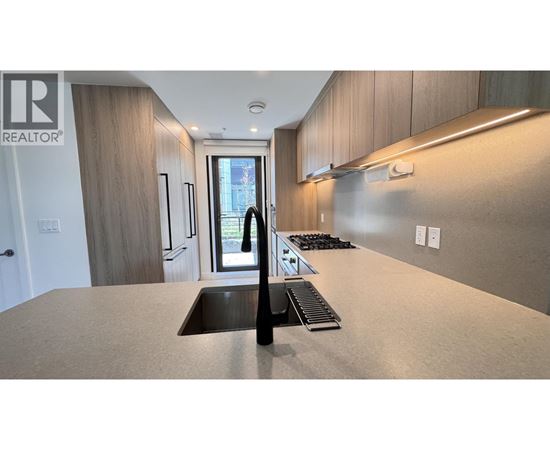 A modern kitchen with a sink and a window.
