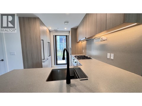 A modern kitchen with a sink and a window.