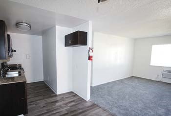 A kitchen area with a sink and a microwave.