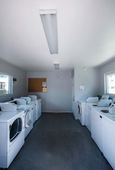 A laundromat with rows of washers and dryers.