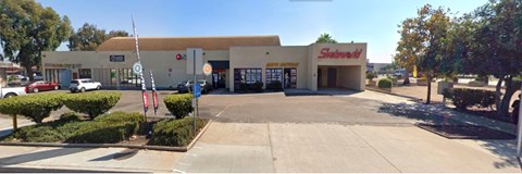A Skadden building with a parking lot in front.