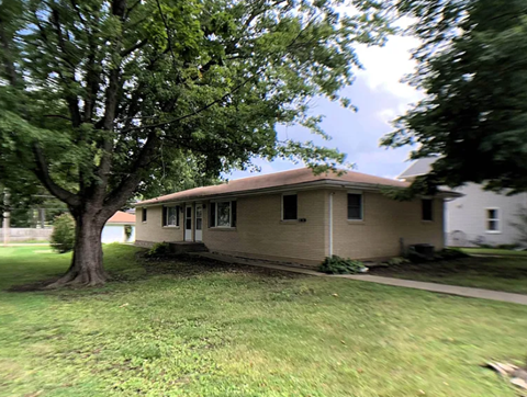 A house with a tree in front of it.