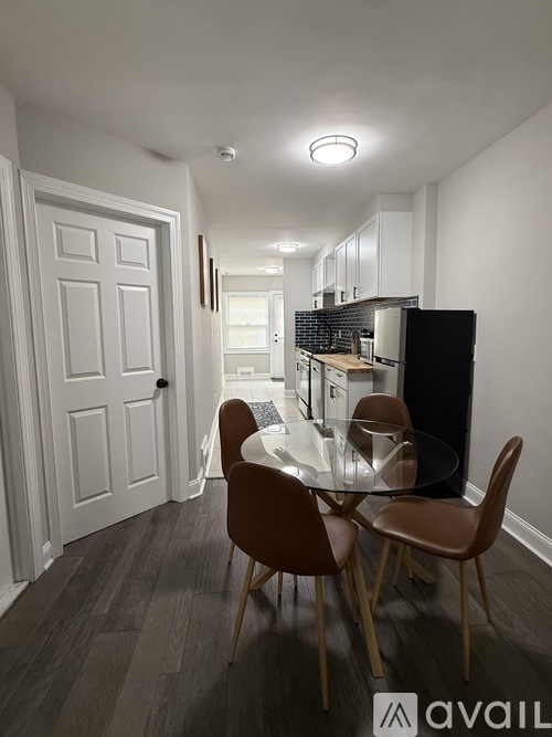 A modern kitchen with a dining table and chairs.