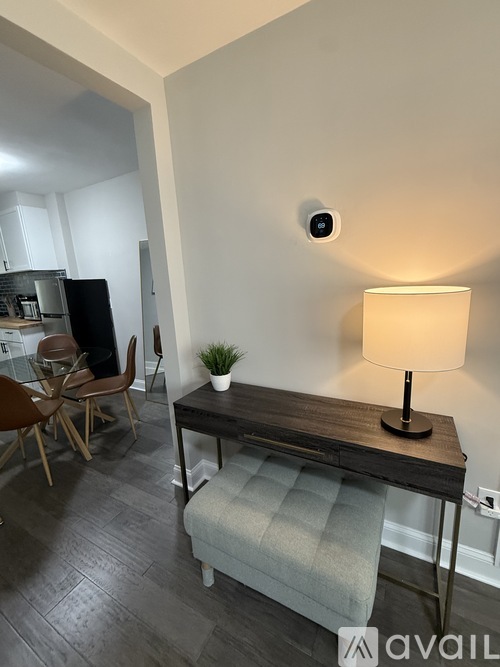 A modern living room with a wooden table and a lamp.