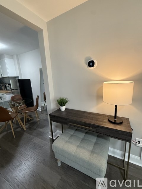 A modern living room with a wooden table and a lamp.