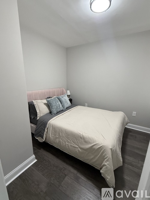 A bedroom with a bed and pillows.