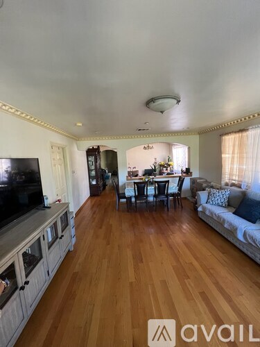 A living room with wooden floors and furniture.