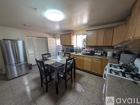 A kitchen with a table and chairs in the middle of the room.