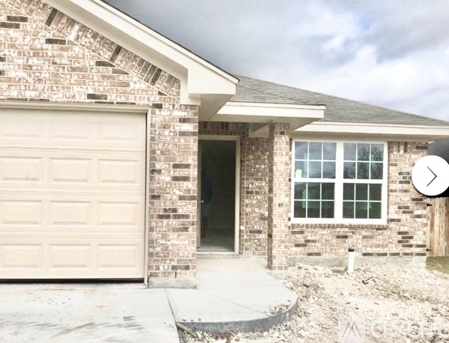 A house with a garage door and a window.