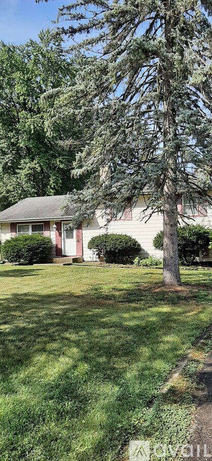 A house with a tree in front of it.