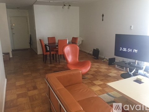A living room with a television and a couch.